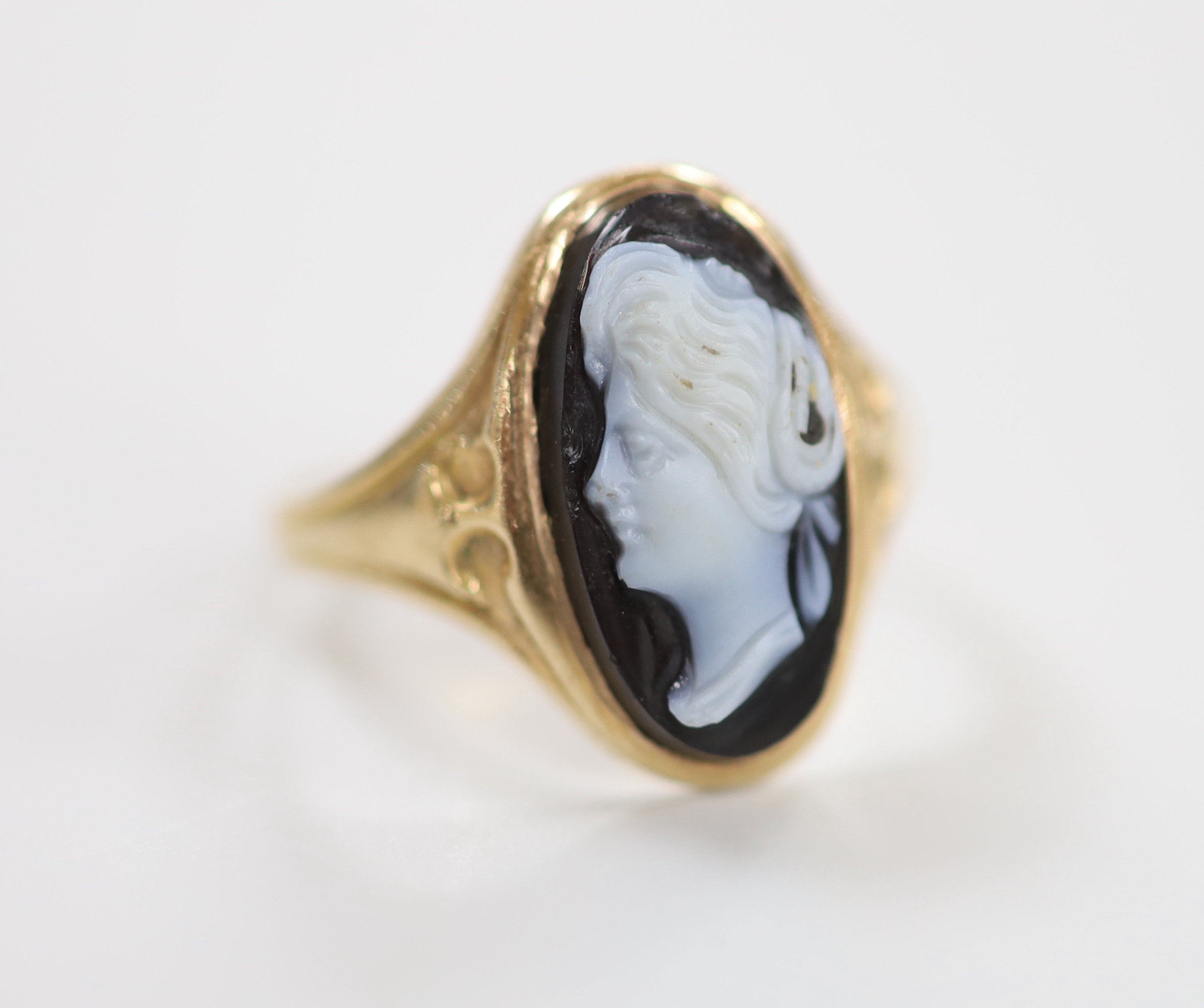 A late 19th century yellow metal and oval cameo set ring, carved with the bust of a lady to dexter, size M/N, gross weight 3.1 grams.